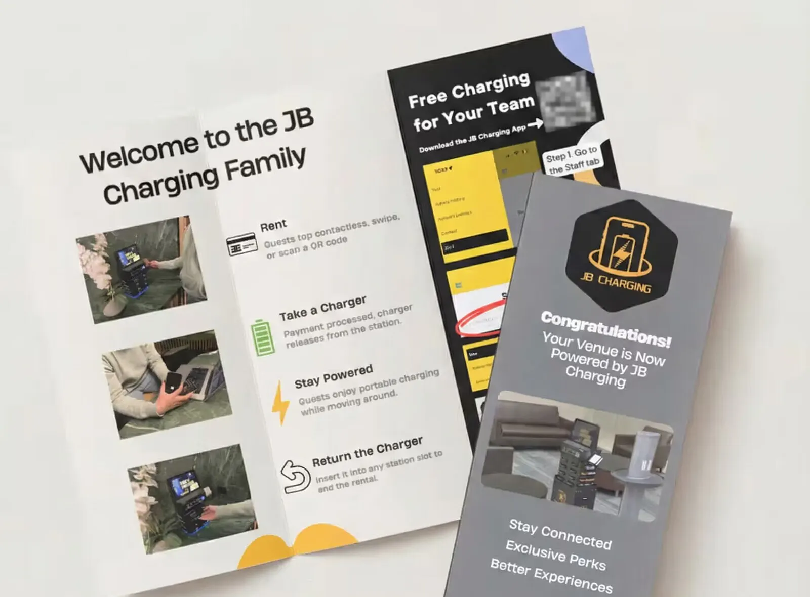 Mockup of JB Charging venue brochures: a fold-out showing four steps (rent, take a charger, stay powered, return the charger) and a gray card telling the venue it is now powered by JB Charging